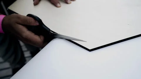 A man cuts a white sheet of paper with scissors. Close-up shooting Stock Footage 342030895