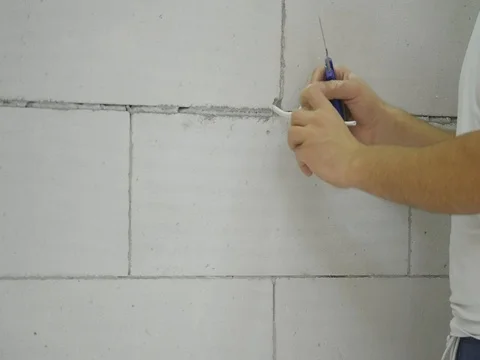 A man cuts the wire in the wall Stock Footage 83756411