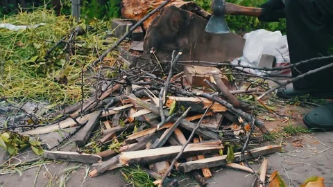 Man cuts wood to build a fire Stock Footage