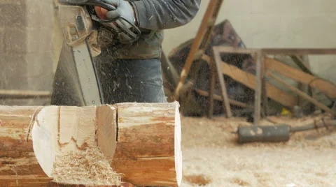 Man cuts wood chainsaw for future home. Protective face mask on the face of the Video stock 69068131