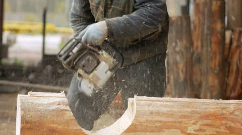 Man cuts wood chainsaw for future home. Protective face mask on the face of the Stock Footage 69068757