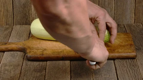 Man cuts zucchini into cubes. Side view. Stock Footage 164055663