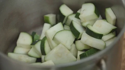 Man cuts zucchini with a knife slow Stock Footage 80243673