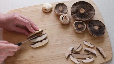 Man cutting Agaricus mushrooms into slices Stock Footage 264059104