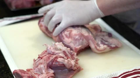 Man Cutting and trimming Large Pork Meat In A Kitchen With Two Knives Stock Footage 140608951