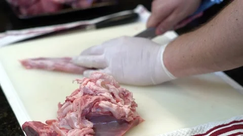 Man Cutting and trimming Large Pork Meat In A Kitchen With Two Knives Stock Footage 140608976