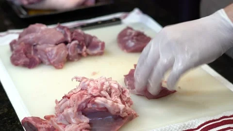 Man Cutting and trimming Large Pork Meat In A Kitchen With Two Knives Stock Footage 140609469