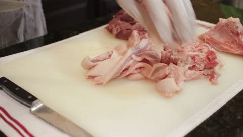 Man Cutting and trimming Large Pork Meat In A Kitchen With Two Knives Stock Footage 140617586