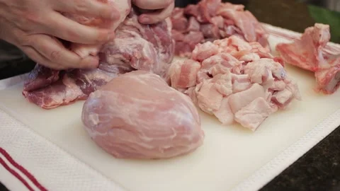 Man Cutting and trimming Large Pork Meat In A Kitchen With Two Knives Stock Footage 140617627