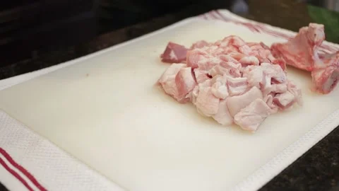 Man Cutting and trimming Large Pork Meat In A Kitchen With Two Knives Video stock 140617631