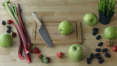 Man is cutting the apple on the kitchen table view from above. Stock Footage 75622104