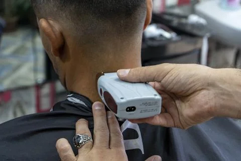 A man cutting back side of a head 스톡 사진