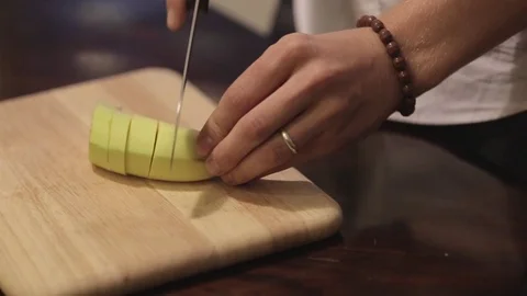 Man cutting a banana in the kitchen. 動画素材 72401401