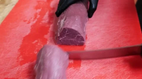 Man cutting beef into equal parts Stock Footage 171360541