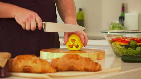 Man cutting bell pepper for salad Stock Footage 130058013