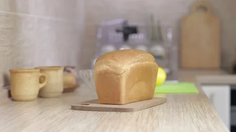 A man is cutting bread with knife (on the kitchen) Stock Footage 54330363