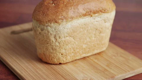 Man cutting bread with knife on the kitchen Stock Footage 102643794