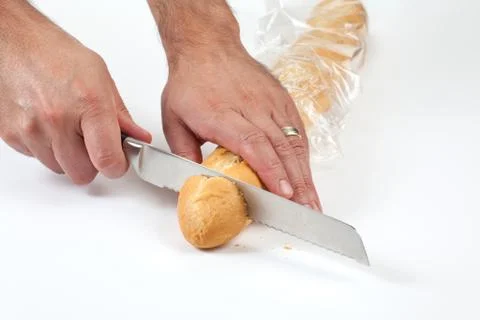 A man cutting bread Stock Photos