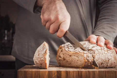 Man cutting bread Stock Photos