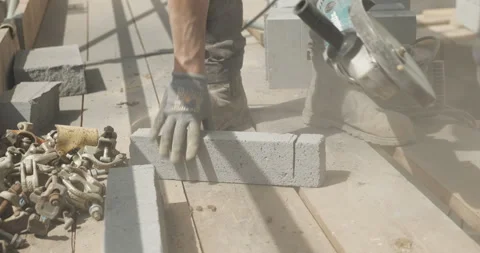 Man cutting into breeze block with circular saw close-up Stock Footage 246380073