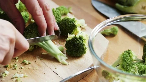 Man cutting broccoli florets Stock Footage 72223548