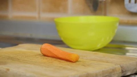 Man cutting carrot with kitchen knife Stock Footage 87301429