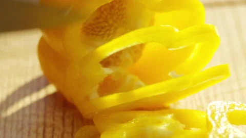 Man cutting carrot on table, close-up. Hands cutting on a cutting board. 4K Stock Footage 132974331