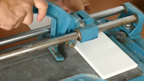 Man cutting ceramic tile with extra precise machine Stock Footage 71112250
