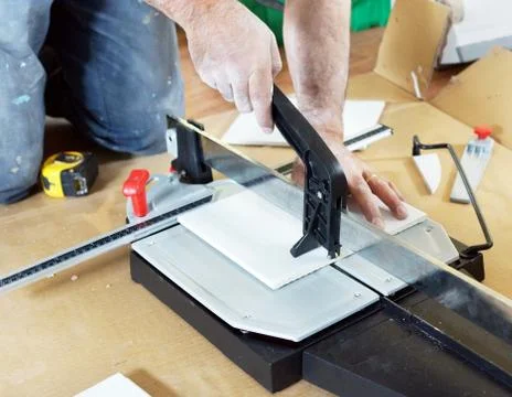 Man cutting ceramic tile Stock Photos