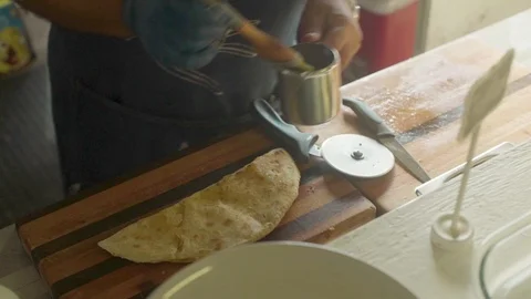 Man Cutting Chapati in Slices Stock Footage 106556554