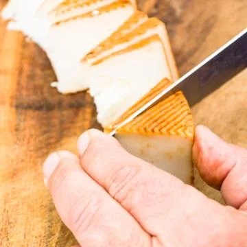 Man cutting cheese Stock Photos