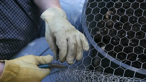 Man cutting chicken wire Stock Footage 39413558