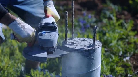 Man cutting a concrete column. Sparks of metal and concrete dust. Construction. Video stock 72599161