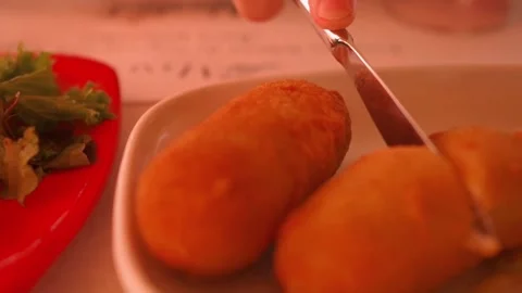 Man cutting croquettes on table with fish fries and other tapas Stock Footage 273833002