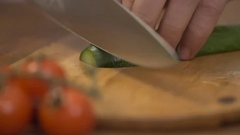 Man cutting cucumber longitudinally Stock Footage 71375892