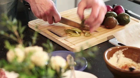 A man is cutting a cucumber into slices Stock Footage 50446927