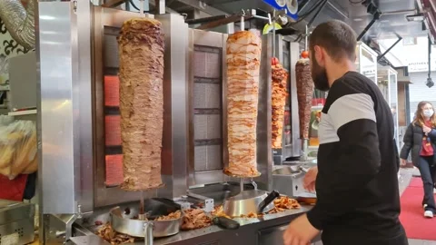A man is cutting a delicious kebab Stock Footage 210216535