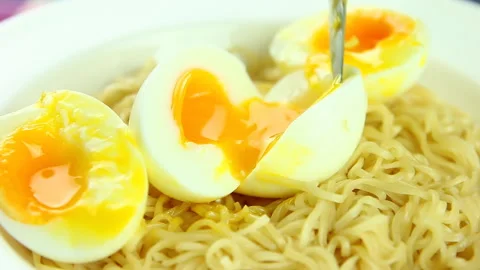 Man is cutting egg in plate, in door  Chiangmai Thailand Stock Footage 165915609