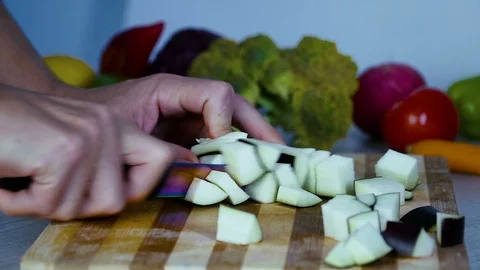 Man is cutting eggplant in the kitchen 動画素材 98202705