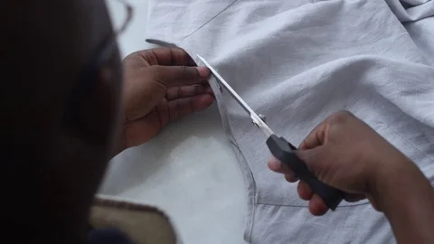 Man Cutting Fabric to Sew Stock Footage 104901349