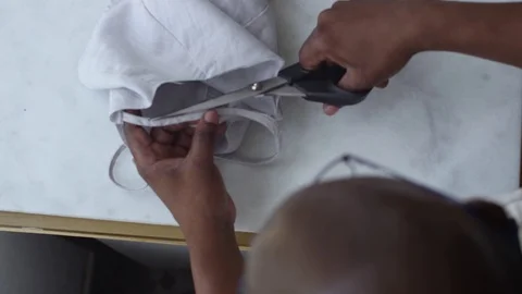 Man Cutting Fabric on Table Stock Footage 104899941