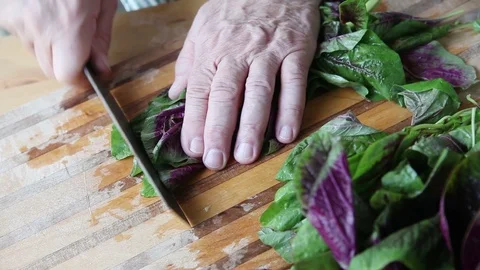 Man cutting up fresh greens Stock Footage 88962857