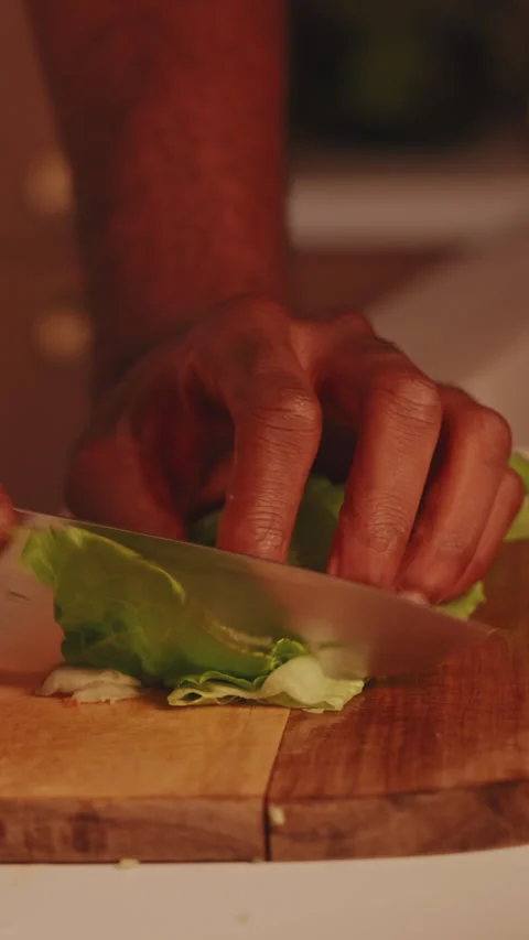 Man Cutting Fresh Lettuce in Kitchen for Healthy Meal Stock Footage 329935551