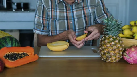 Man cutting fresh mango into cubes in the kitchen Stock Footage 266713336