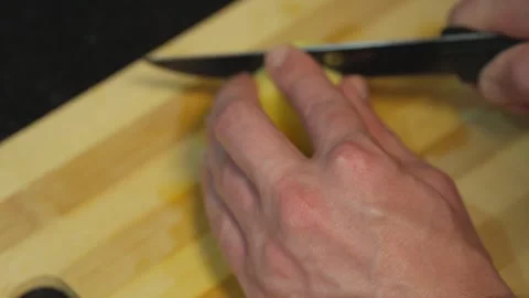 Man cutting fresh peeled raw potato on wooden board Stock Footage 346126499