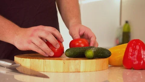 Man cutting fresh red tomatoes Stock Footage 130057819