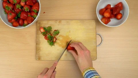 Man cutting fresh strawberry at the kitchen. Stock Footage 108431637
