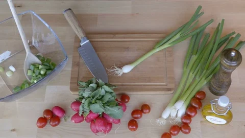 Man is cutting the green onion on the kitchen table view from above. Stock Footage 75623086