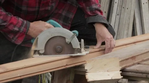 Man cutting  with a hand-held circular saw Stock Footage 59121970