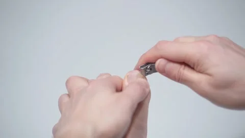 Man is cutting her nails on toes using nippers by herself. Stock Footage 328416744